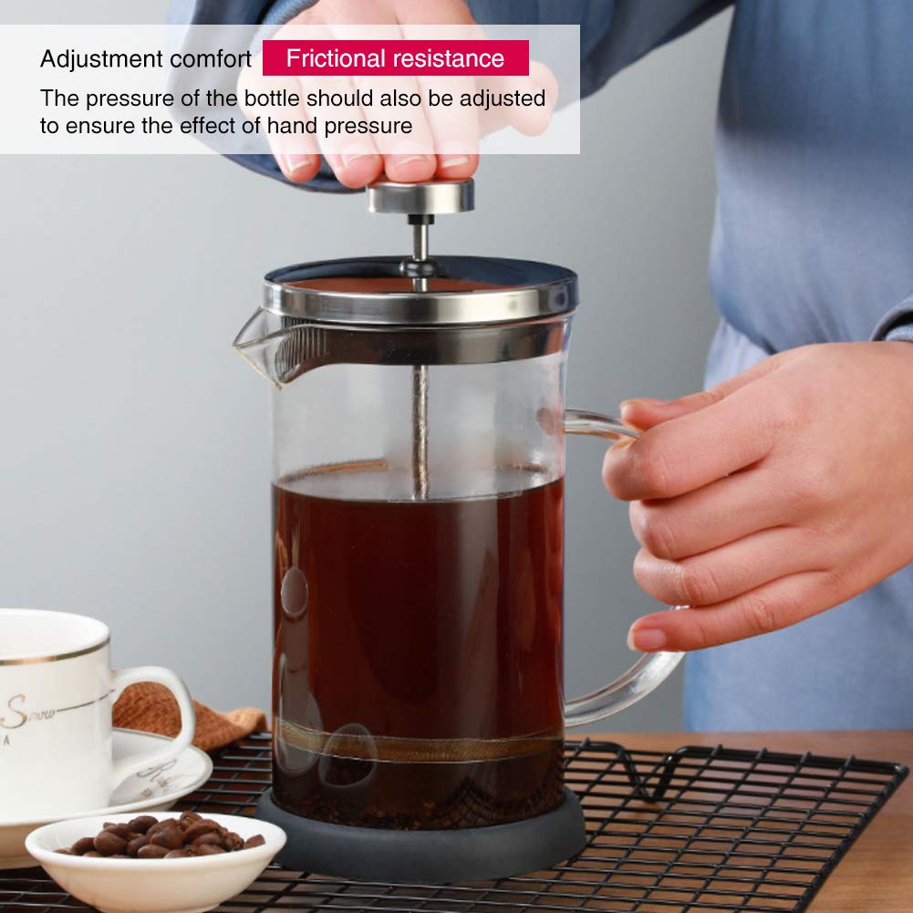 A Person is Making Coffee Using French Press Coffee Maker