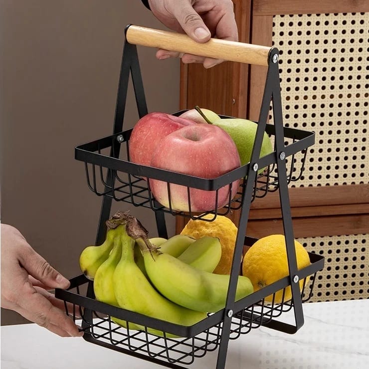 A Person is Holding Fruit Display Stand.