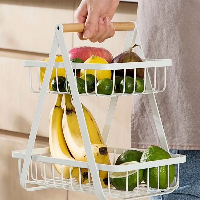 A Person is Holding a Fruit Display Stand With Fruits.