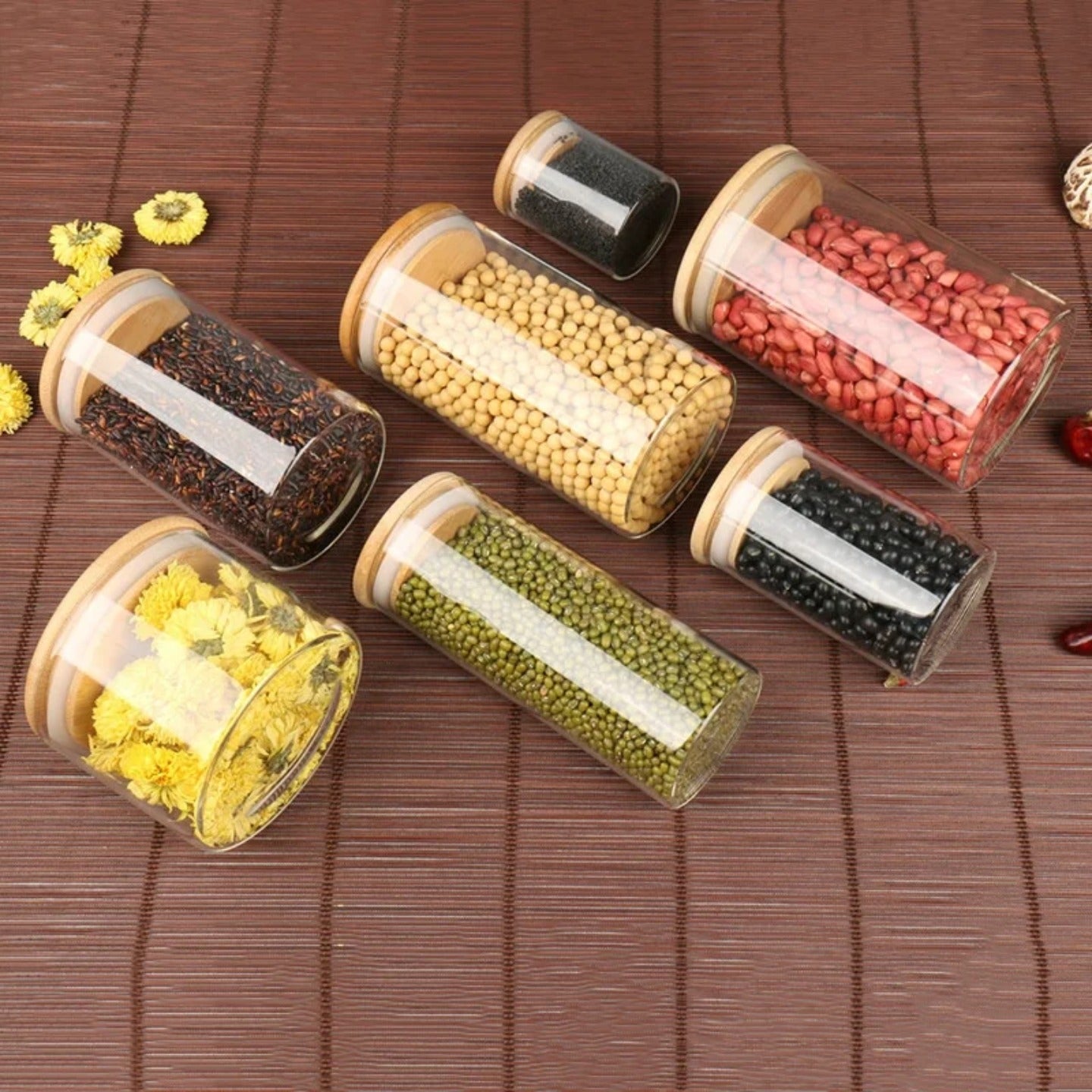 A Set Of Glass Storage Jars  are Filled with Spices.
