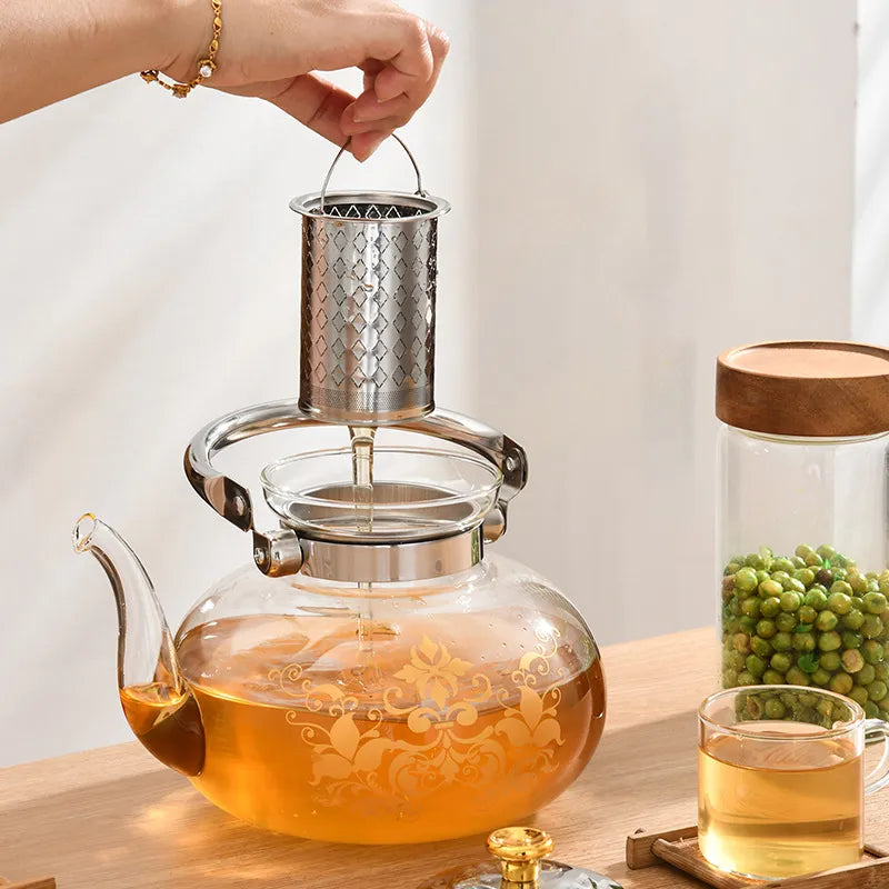 A Person is Holding the Filter of Glass Tea & Coffee Pot.