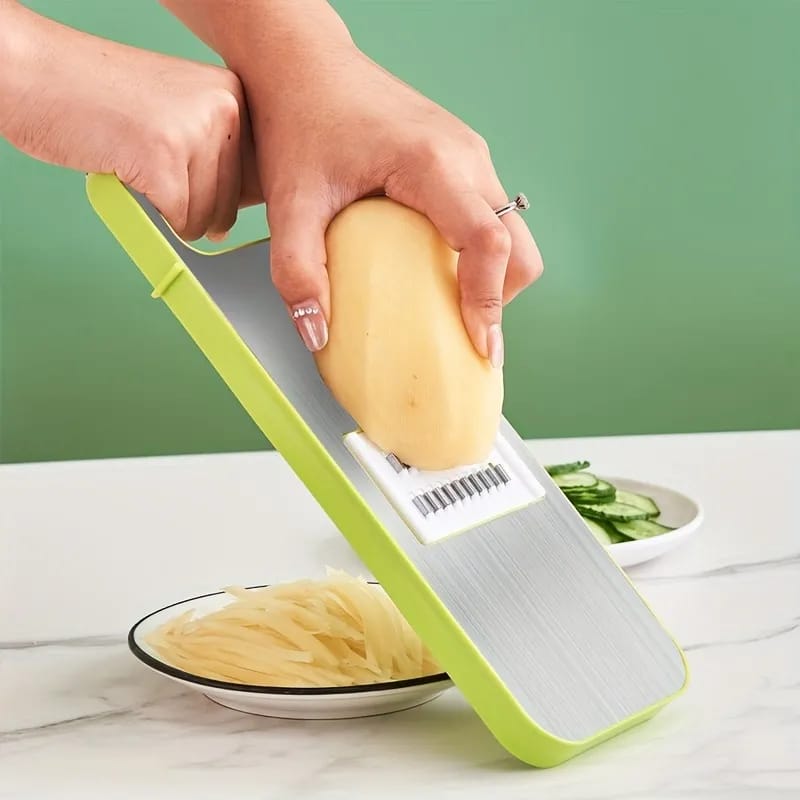 Slicing potato with vegetable slicer.
