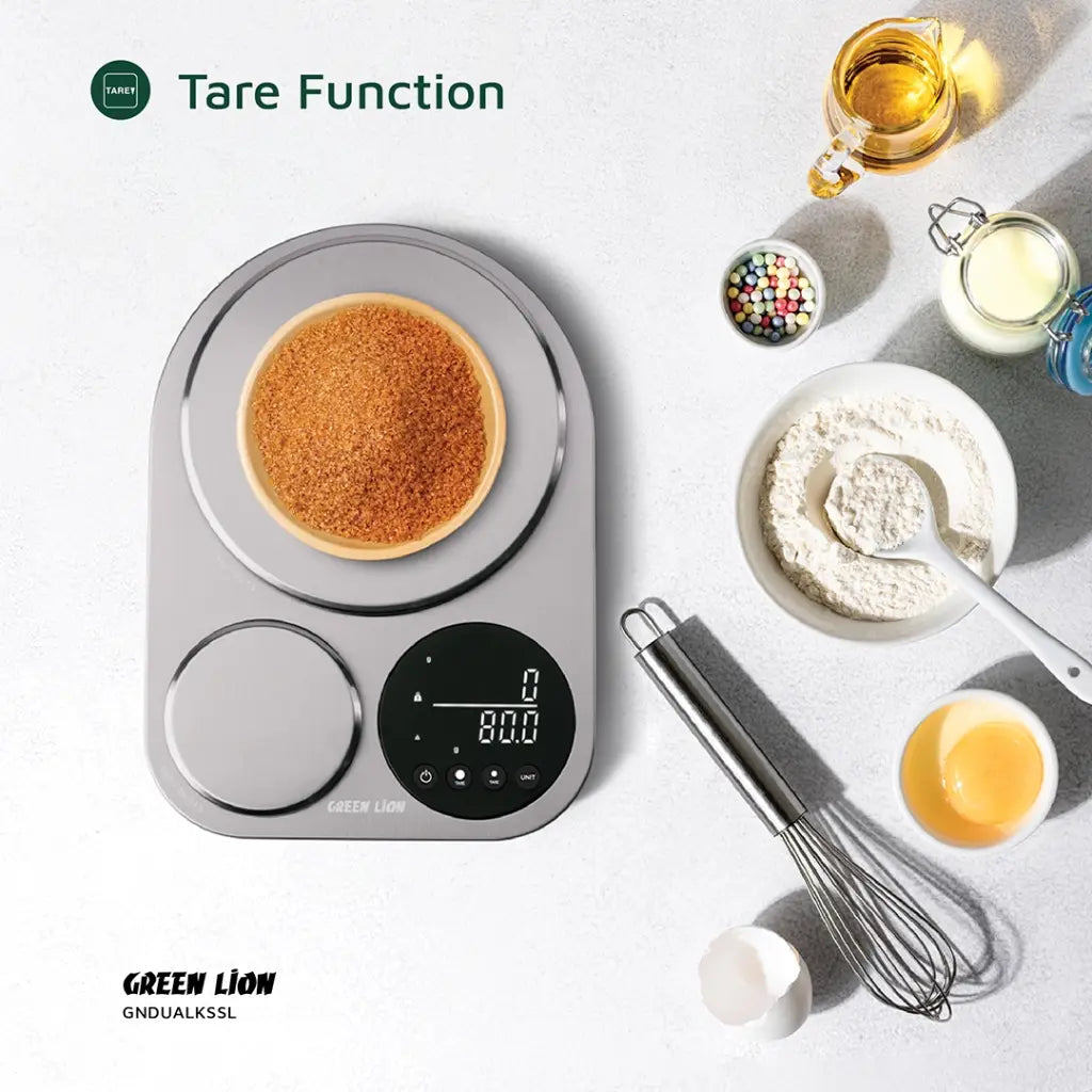 Green Lion Dual Kitchen Scale measuring food portions with large and small platforms, digital display, surrounded by flour and other food items.