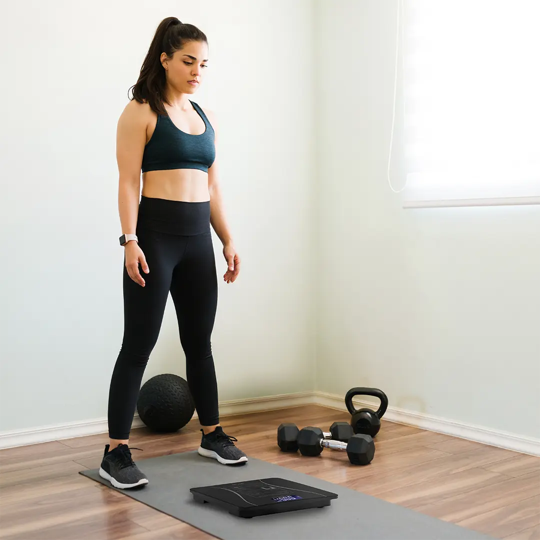 A Woman is Testing Her Weight iUsing Green Lion Smart Body Scale Lite.