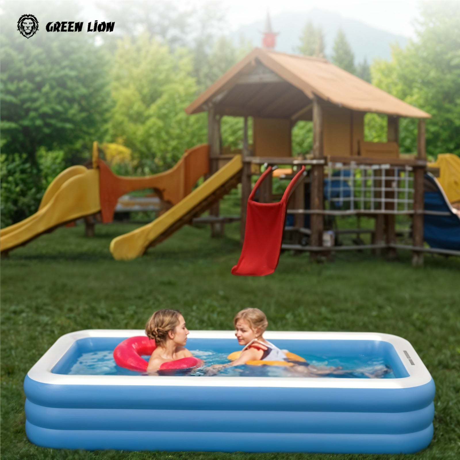 Two children playing and enjoying in a Green Lion Inflatable Swimming Pool, set up outdoors near a playground on a grassy area.