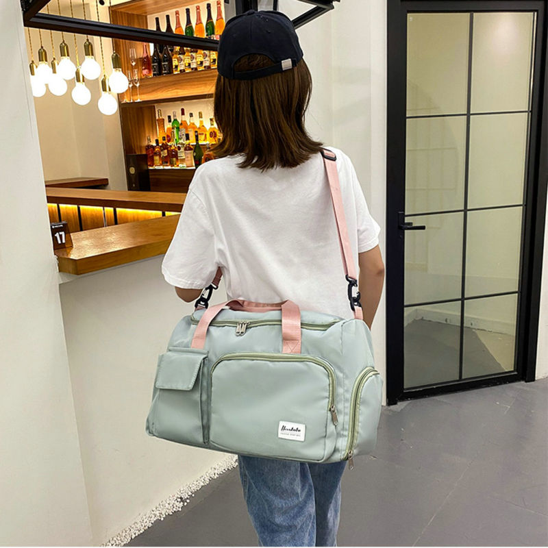 A Women is Carrying Multi-Pocket Travel Duffle Luggage Bag.