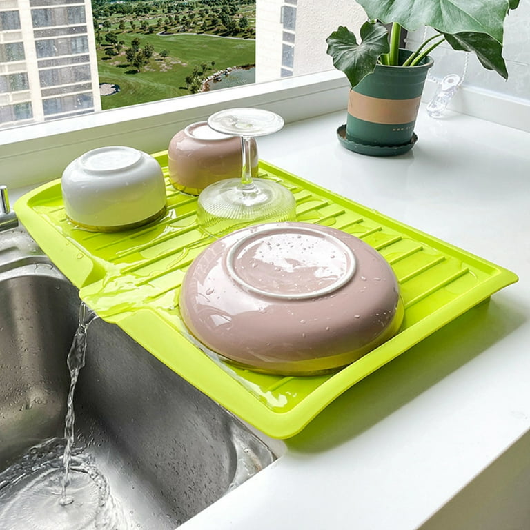 Utensils Are Placed On The Sink Dish Drainer Tray Rack.