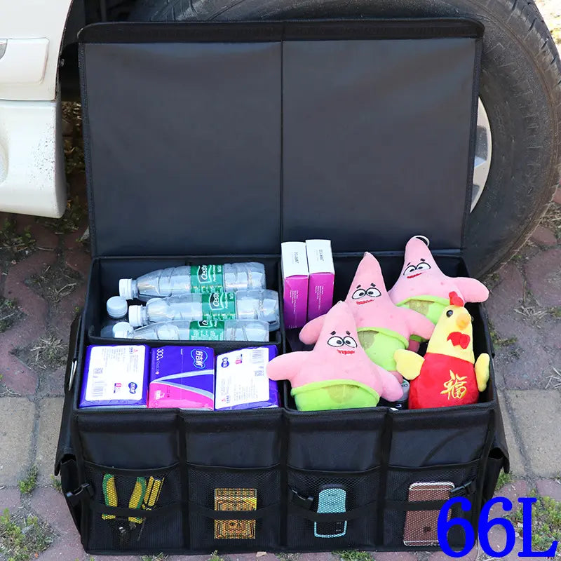 A car trunk storage organizer box with items inside of it