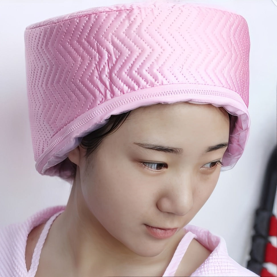 A lady enjoying a deep-conditioning session with a Multi-Purpose Electronic Hair Treatment Cap.