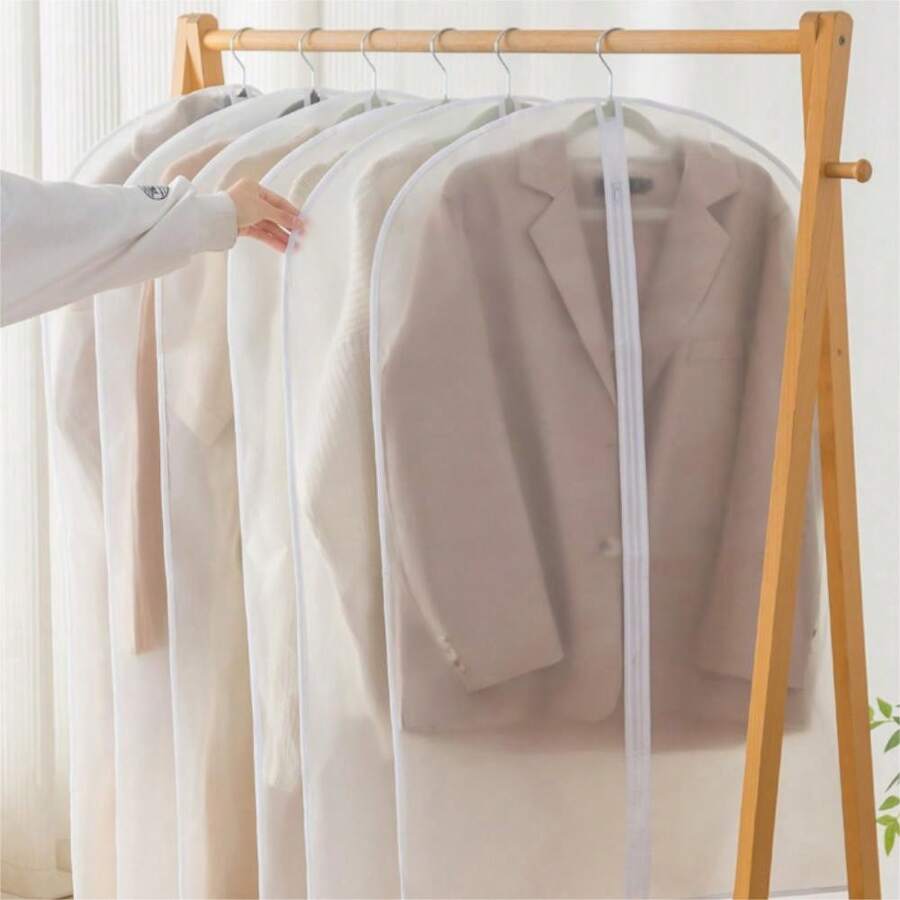 A Person is Picking Cloths From Hanging Garment Bags.