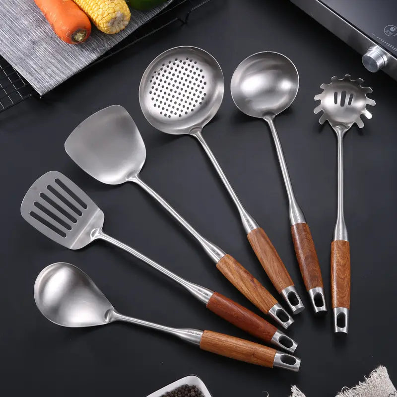 6 Pcs Stainless Steel Kitchenware Spatula Set with Wooden Handle placed on the floor next to something