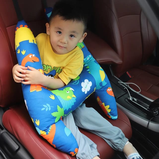 A child sitting in a car with the assistance of a Car Seat Travel Pillow