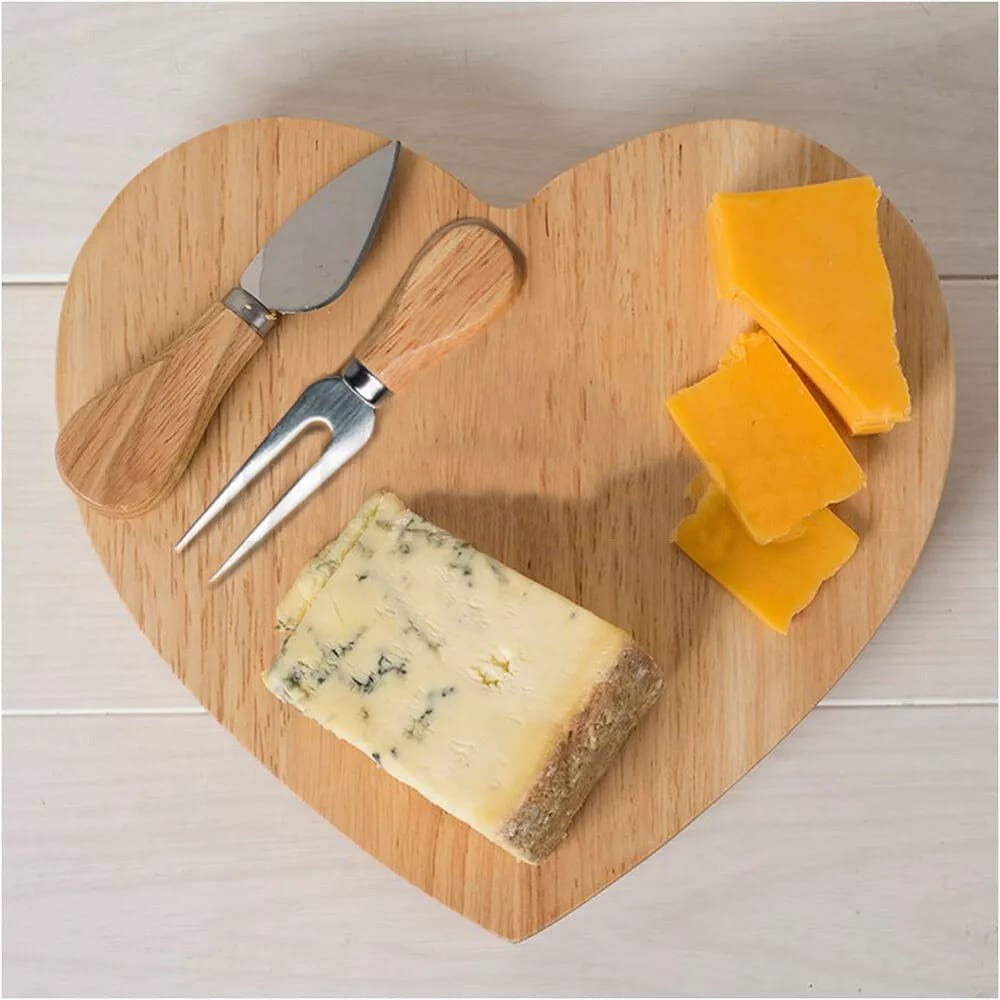 Heart-shaped wooden cheese board with built-in knife storage and served cheese and crackers.