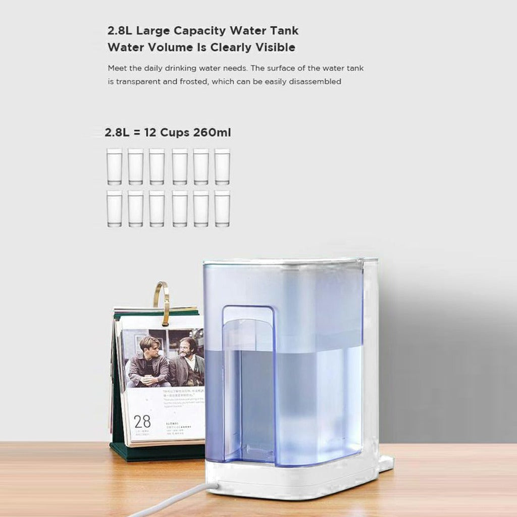 2.8L Instant Heating Desktop Water Dispenser placed on the table next to a colander