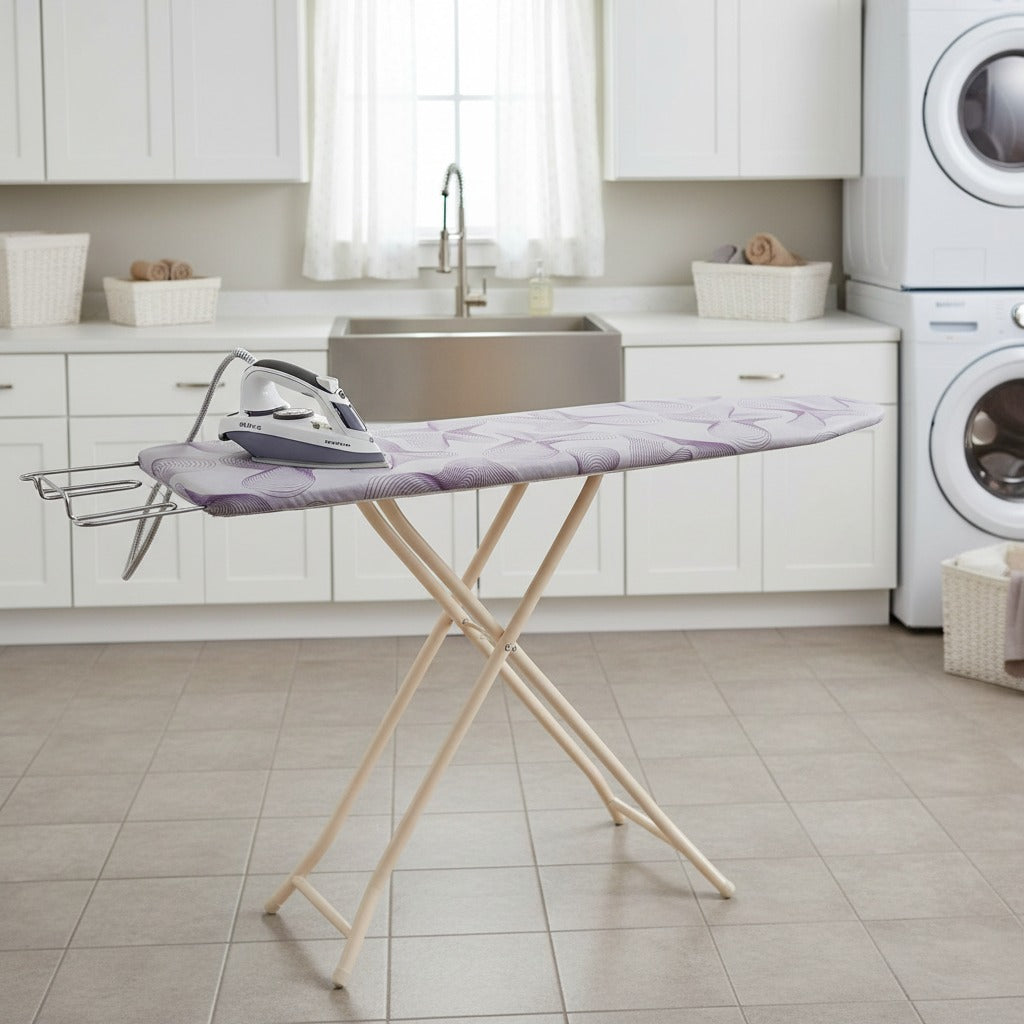 Heavy-duty folding ironing board with iron and clothes set up in a laundry area.