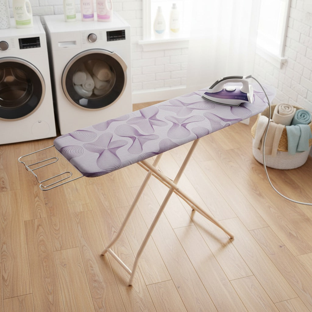 Heavy-duty folding ironing board with iron and clothes set up in a laundry area.