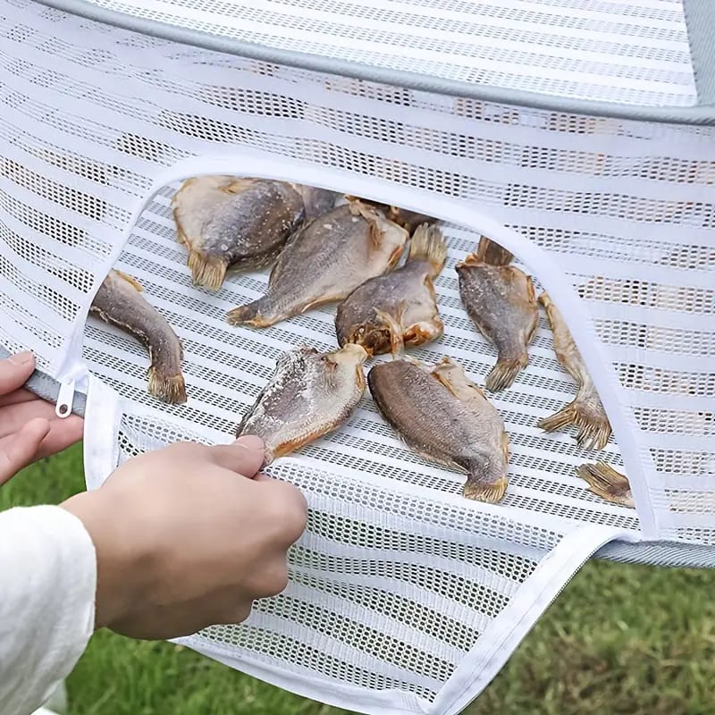 A Woman is Keeping Fish in a Herb Drying Rack Net For Drying.