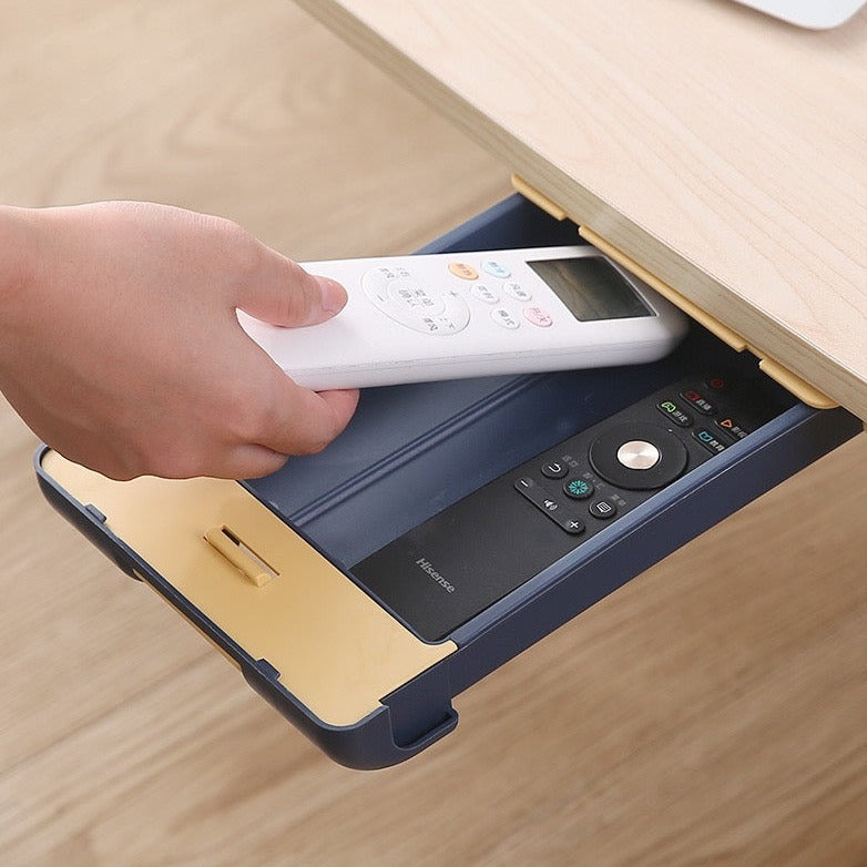 Someone putting a remote into Hidden Drawer Pencil Rack