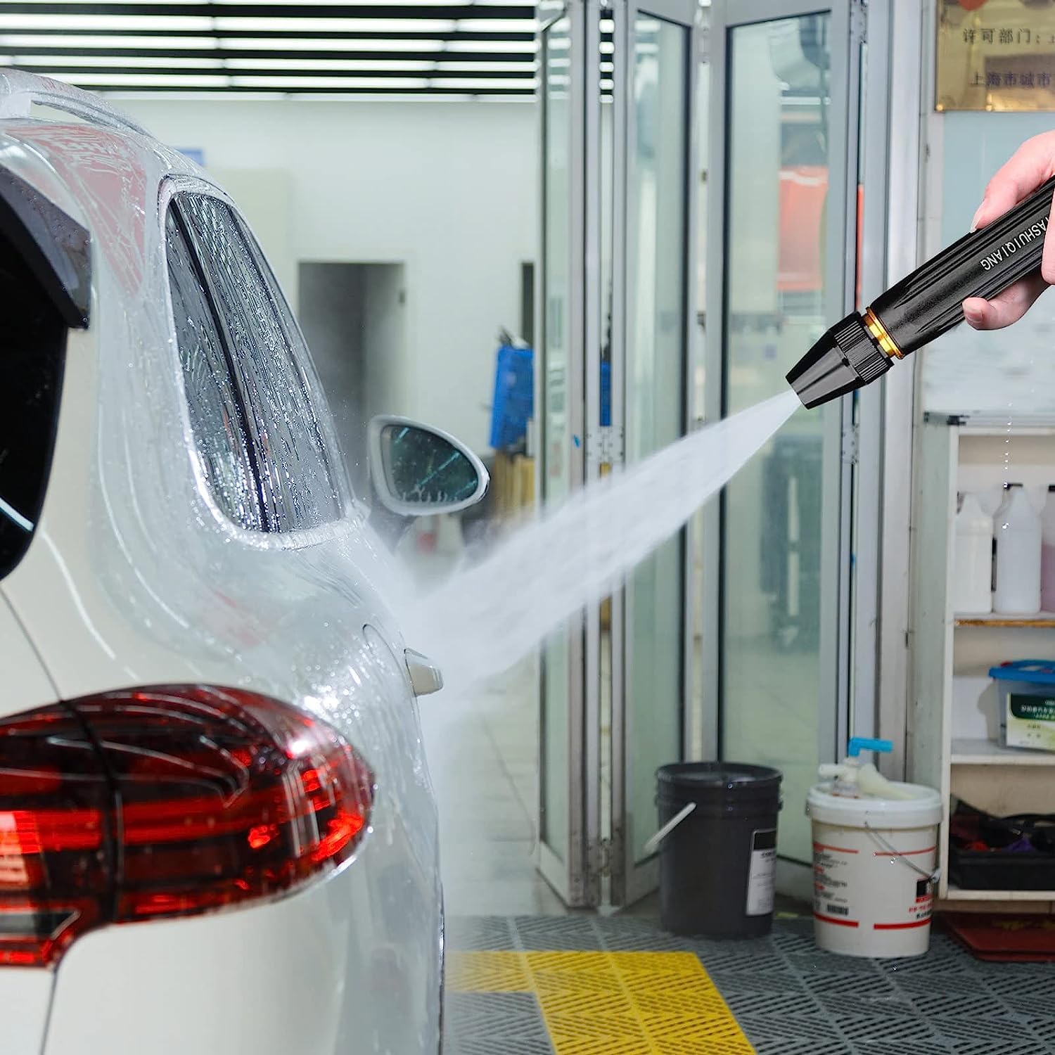 A Person is Washing Car Using High Pressure Car Washing Water Spray Gun Set.