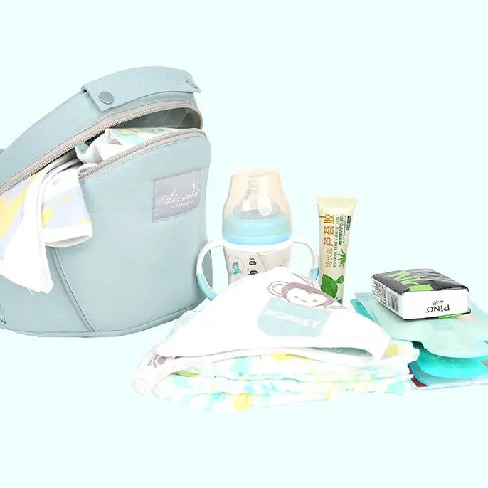 All-Position Baby Carrier placed next to some items