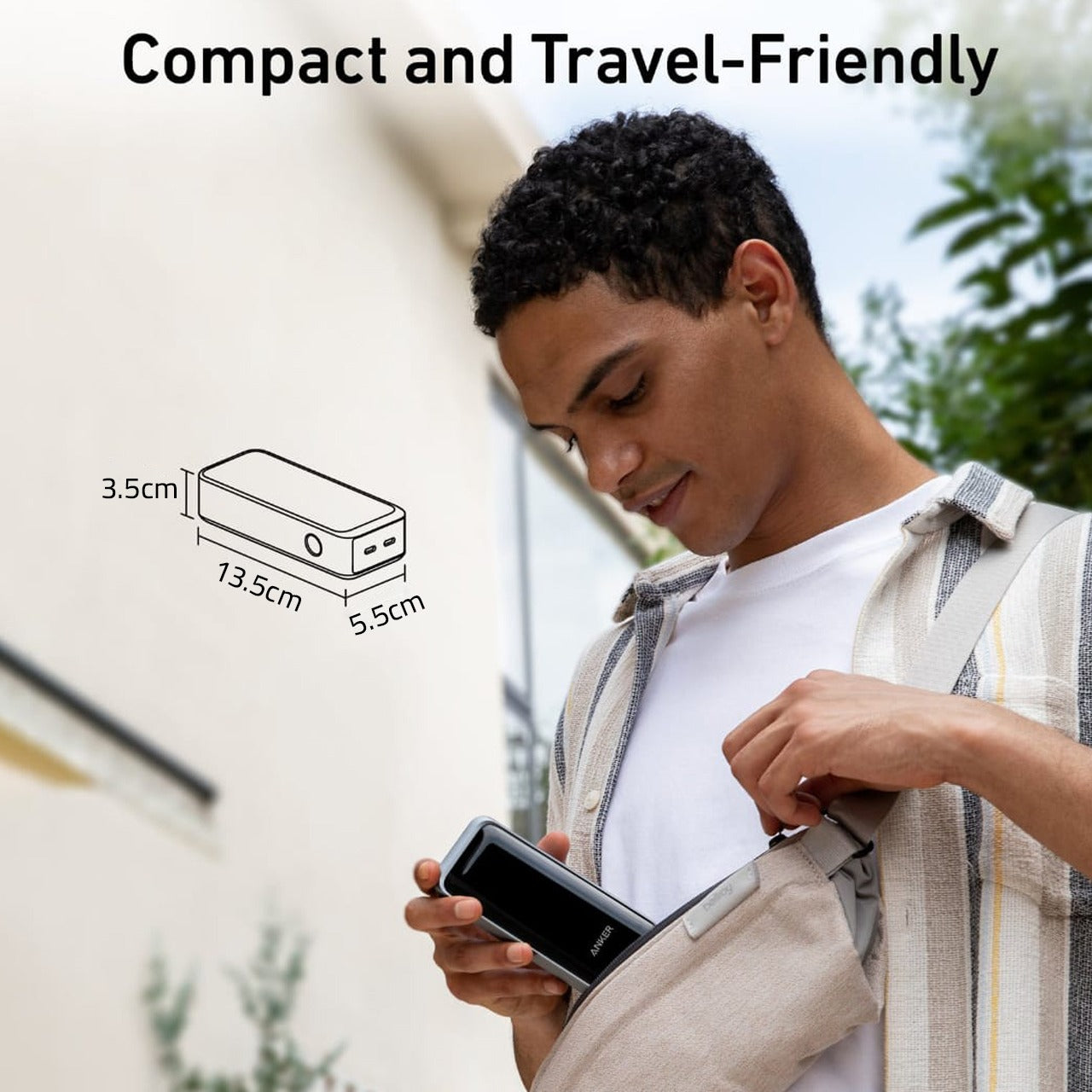 A Person is Placing Anker Prime 12,000 mAh Power Bank (130 W) -A1335011 In to His Bag