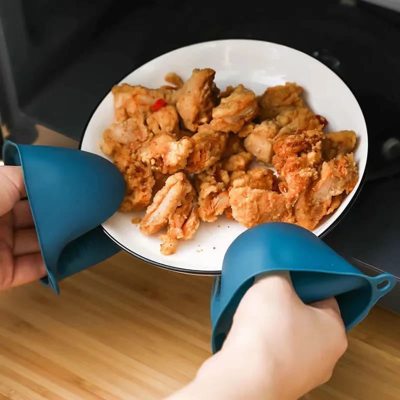 A Person is Holding Dish Using Heat Resistant Protective Gloves.