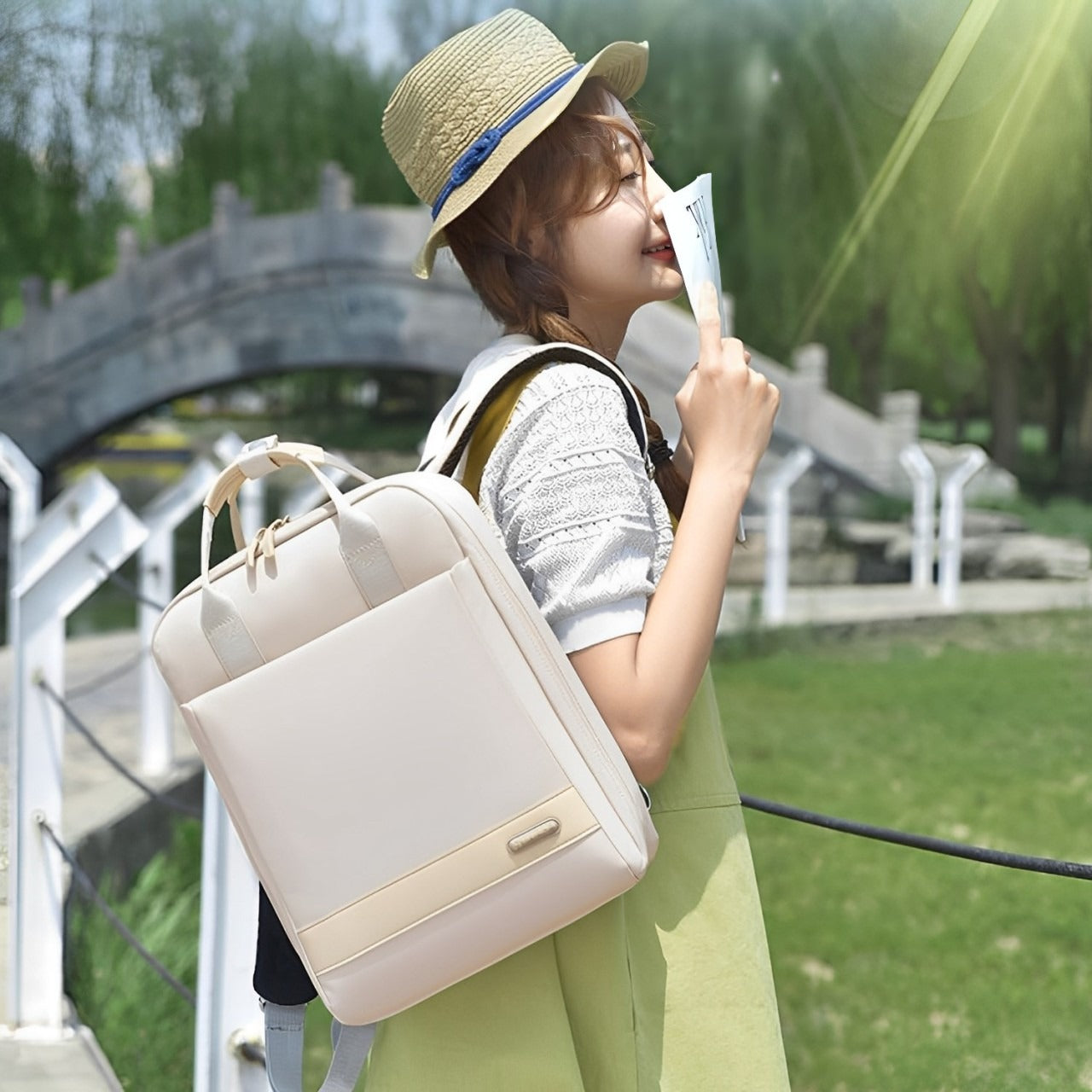 A Women is Holding Stylish  Laptop Backpack with USB Charging.