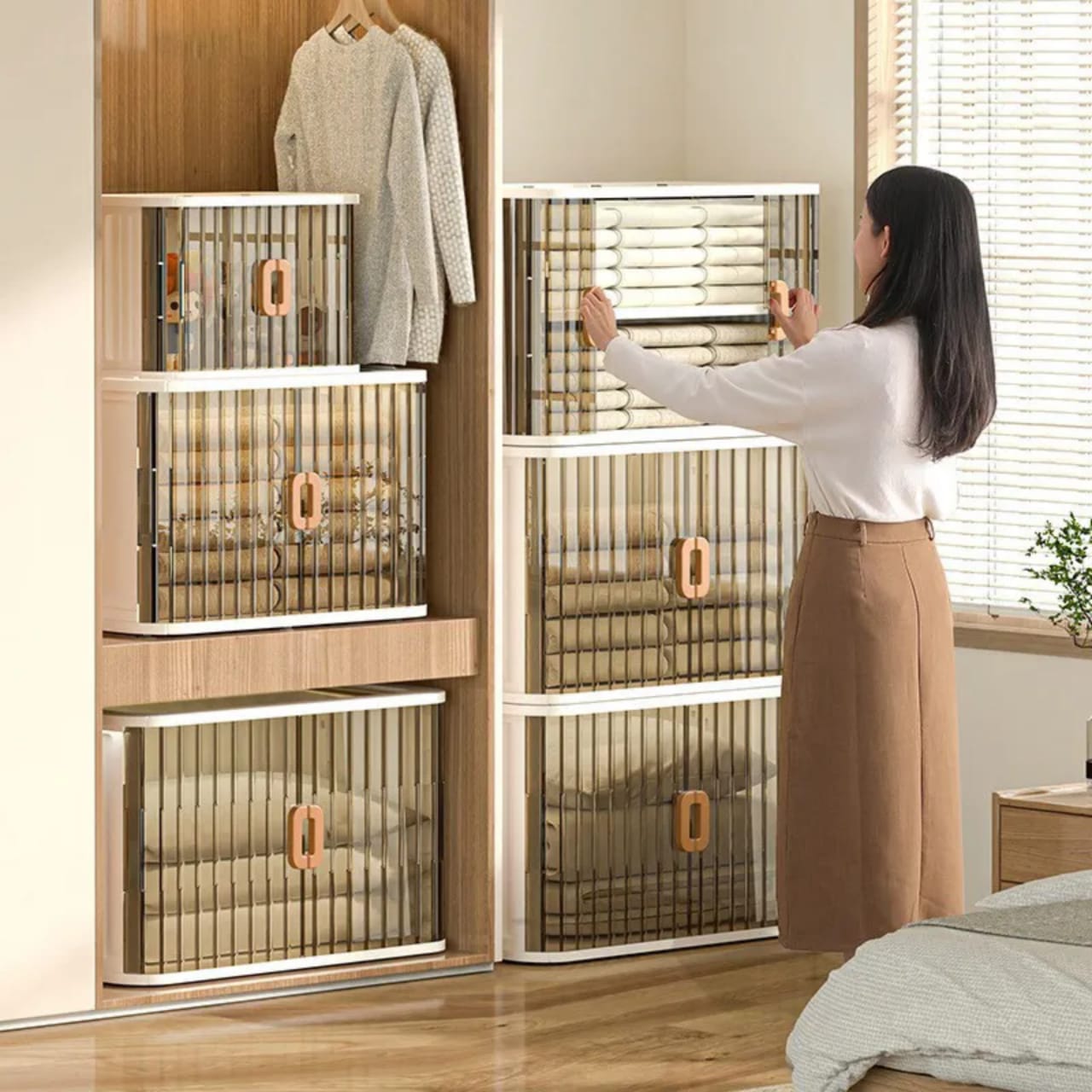 A Woman is Arranging Her Cloths in a Home Storage Bins.