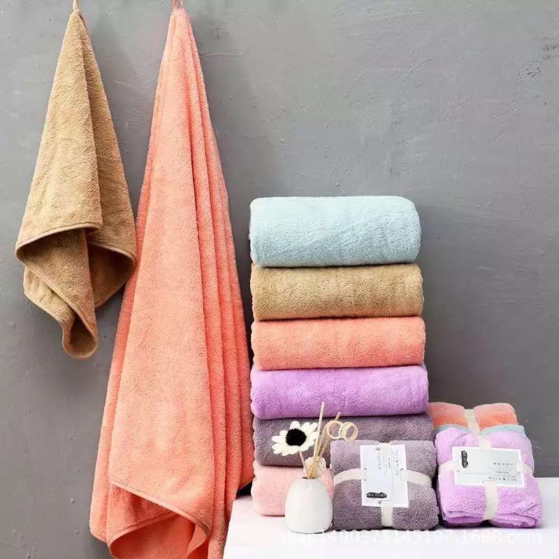 A stack of bath towel sets for kids and adults in different colors