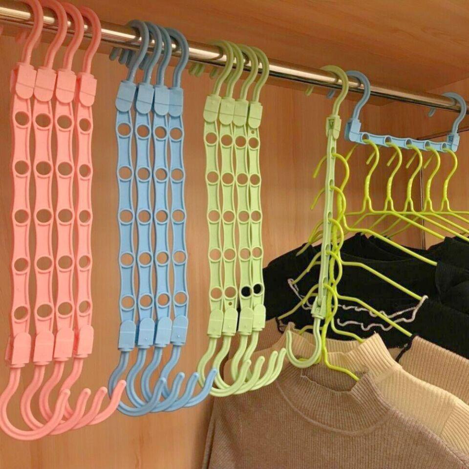 A collection of garments hanging on Multifunctional Adjustable Hook Cloth Hanger, organized on a rack
