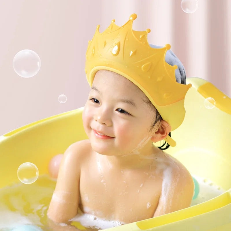 Baby wearing a baby shampoo cap