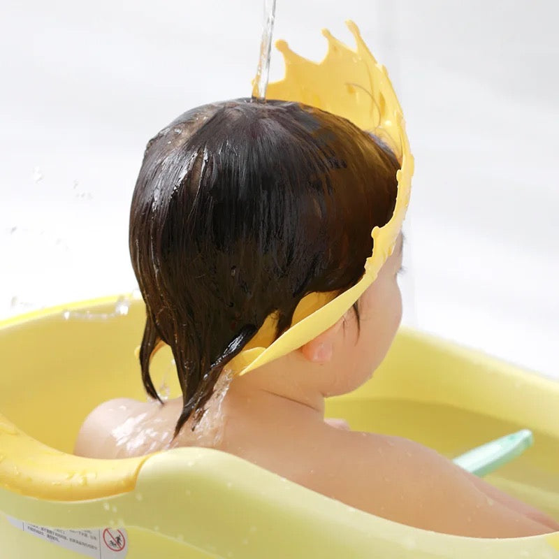 Baby wearing a baby shampoo cap
