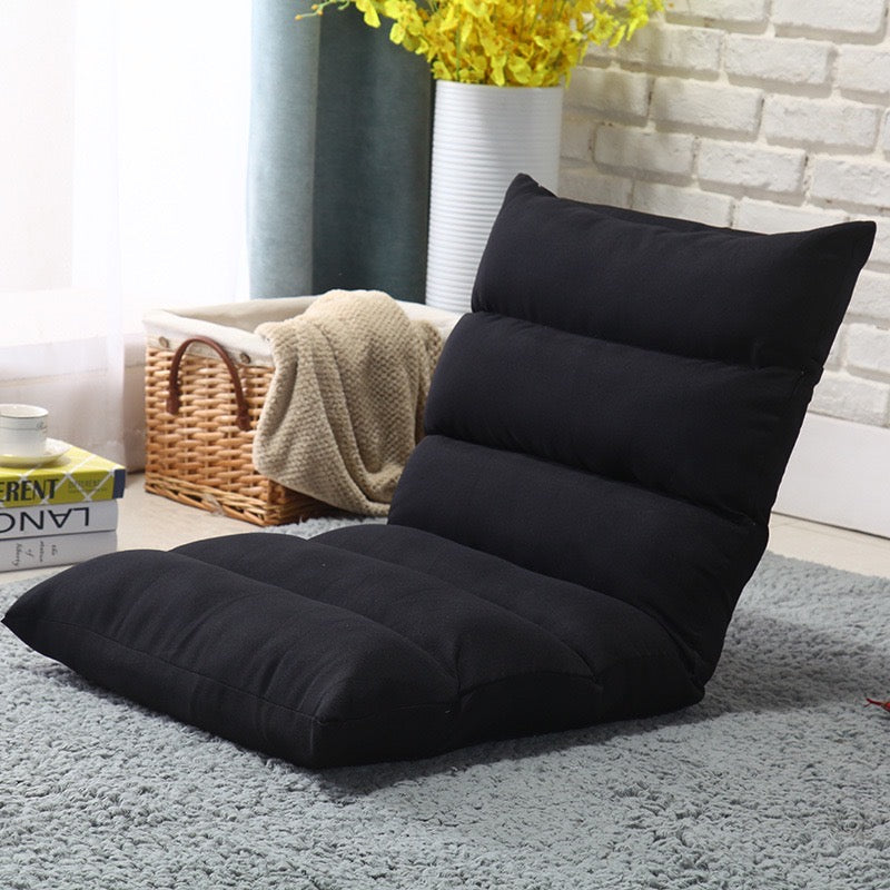 Black color Lazy Lounge Sofa Bed placed near to a basket with cloths