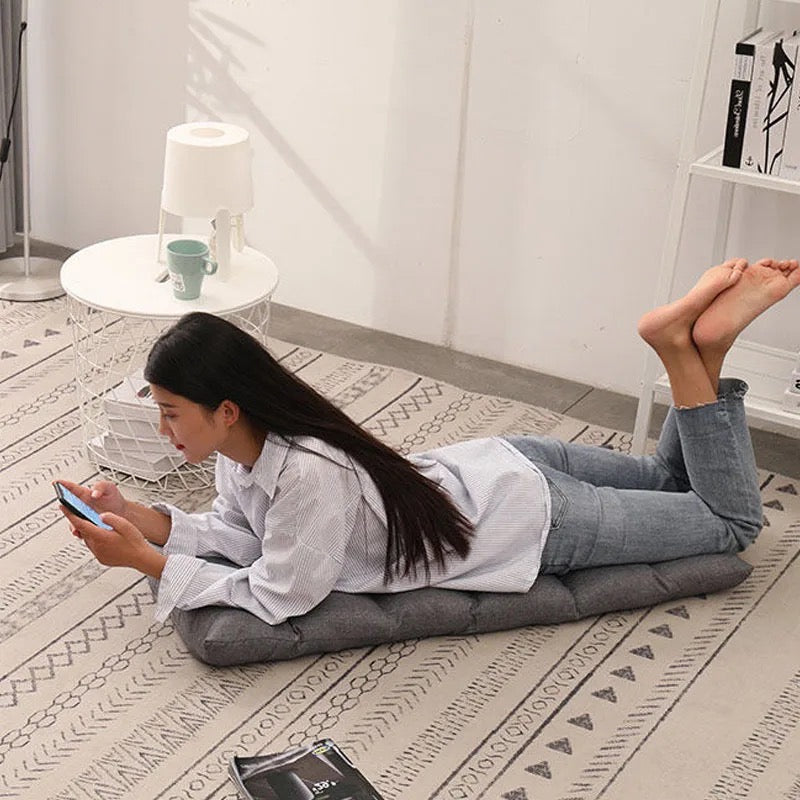 A lady lying on a Lazy Lounge Sofa which is converted to Bed 