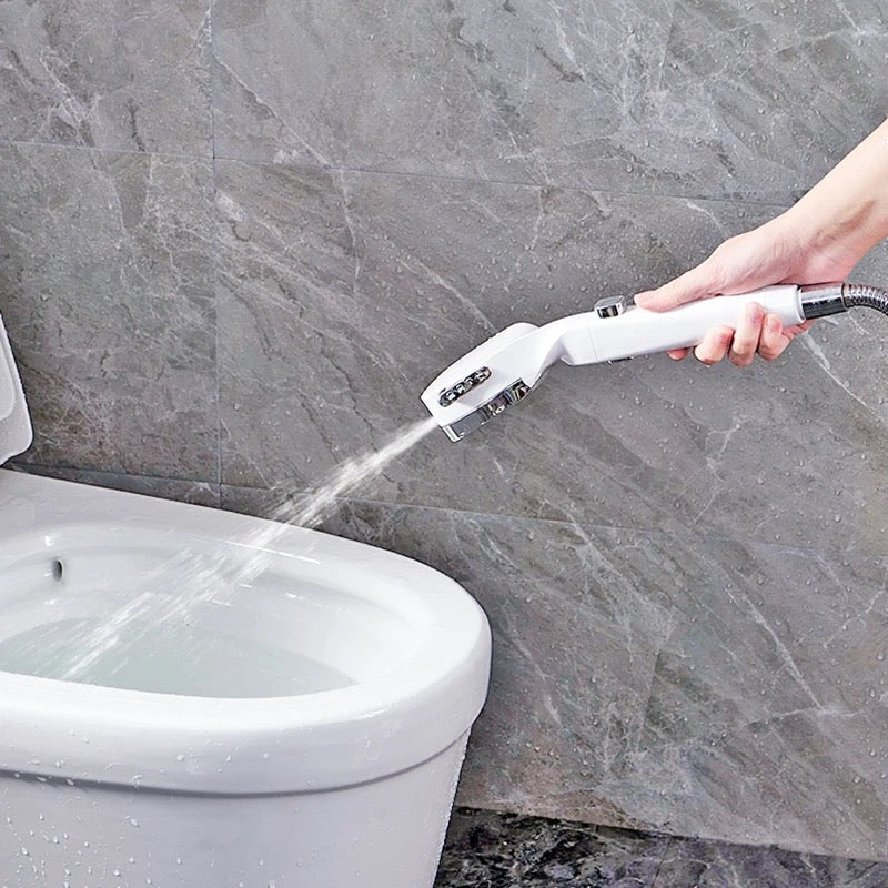 Someone cleaning a toilet with the help of a 4 Modes High-Pressure Shower Head