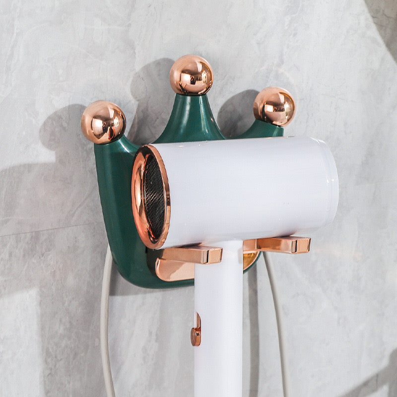 A wall-mounted hair dryer holder with a gray hair dryer attached
