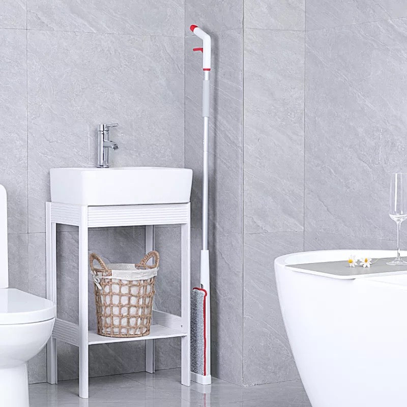 Hands-Free Spray Mop with Self-Wringing Function placed in the bathroom leaning back to the wall