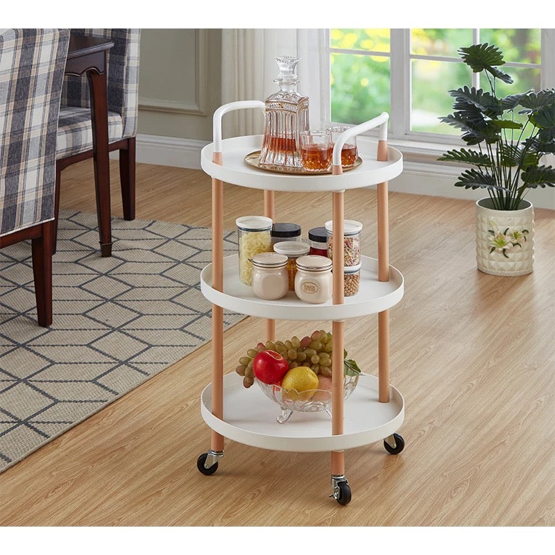 Multi-tier mobile storage table placed on the floor and arranged with some foods