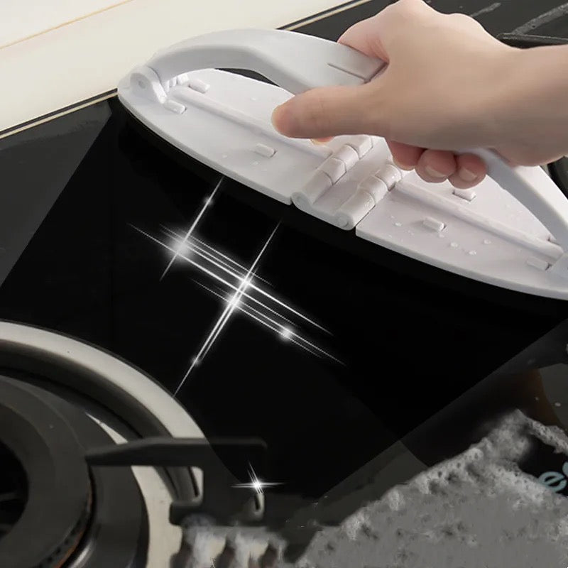 Someone cleaning the stove with the help of a Portable Sponge Cleaning Brush