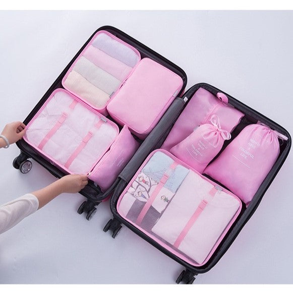 Woman neatly arranging clothes in a suitcase, utilizing Travel Packing Organizer Bags for efficient packing