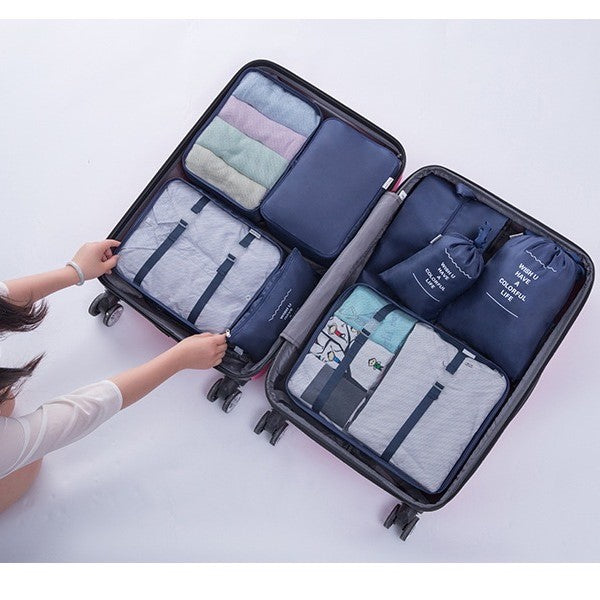 Woman neatly arranging clothes in a suitcase, utilizing Travel Packing Organizer Bags for efficient packing