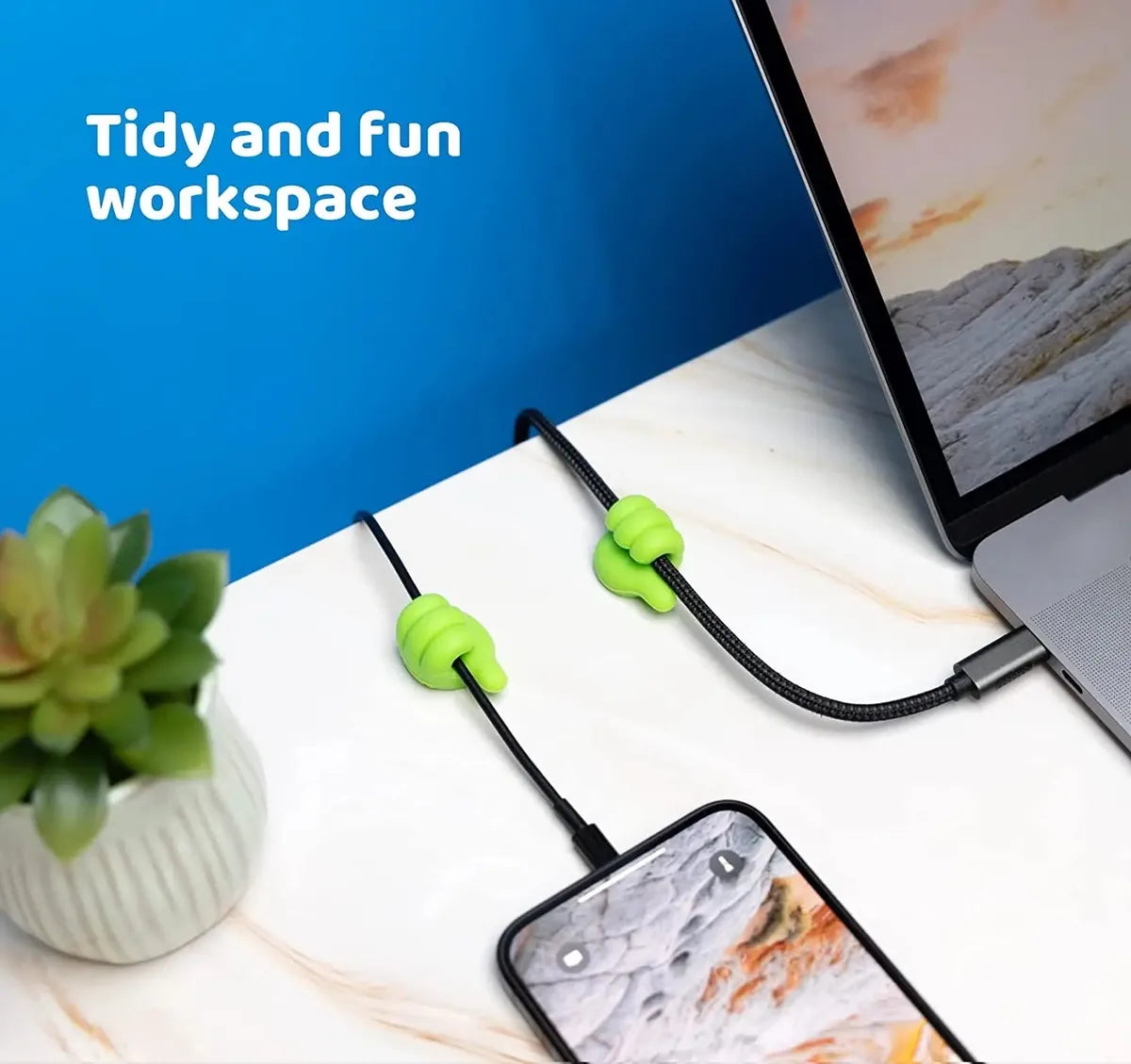 A laptop and phone cable connected to Silicone Thumb Hook Cable Manager