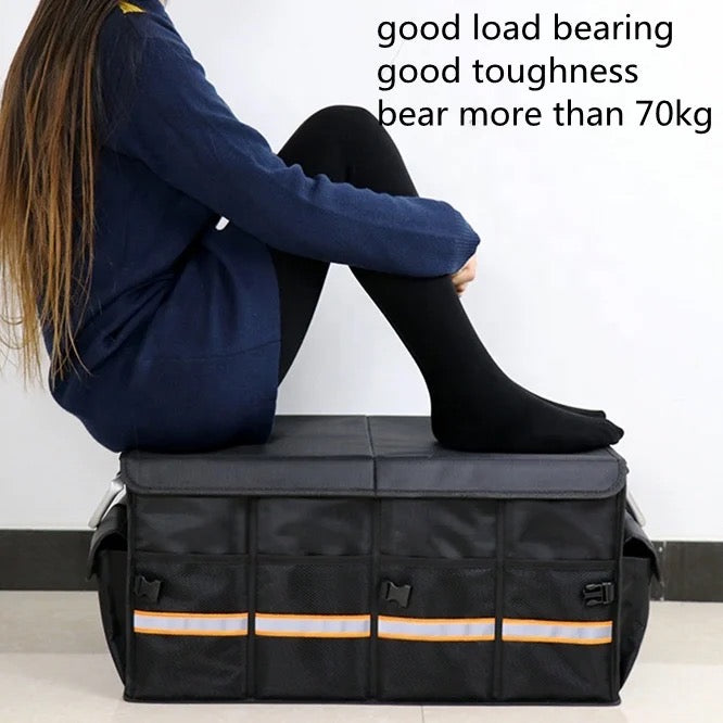 A person sitting on a car trunk storage organizer box