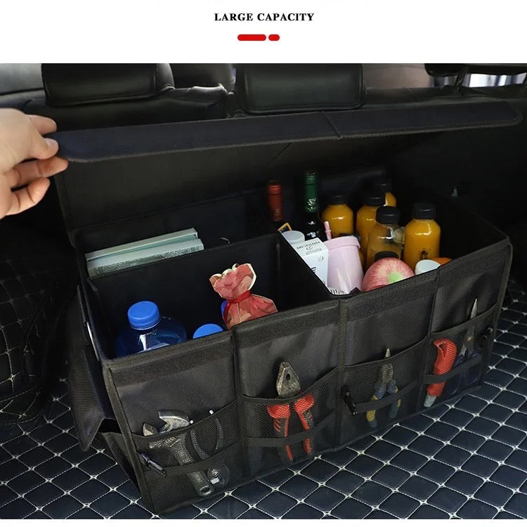 A car trunk storage organizer box with items inside of it