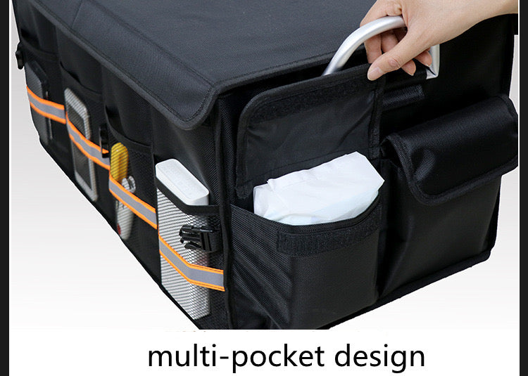 A car trunk storage organizer box with items inside of it
