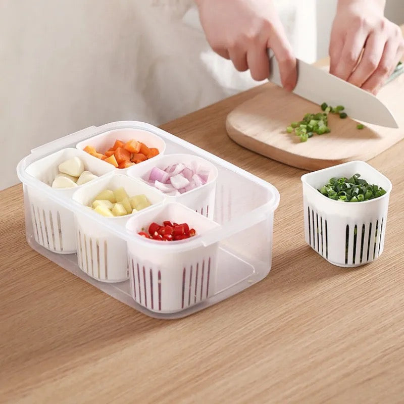 A person neatly slices vegetables into small containers, using a 6-Grids Useful Refrigerator Food Fresh-keeping Storage Box