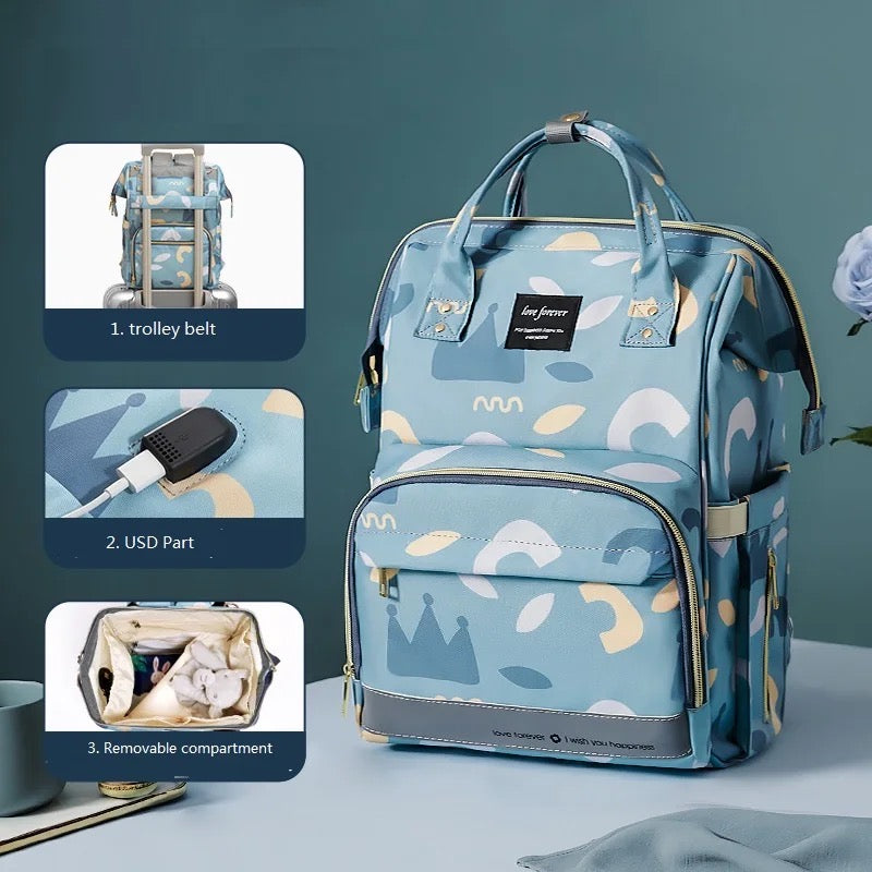 A stylish waterproof mummy backpack with a blue pattern on it, perfect for travel and as a diaper bag