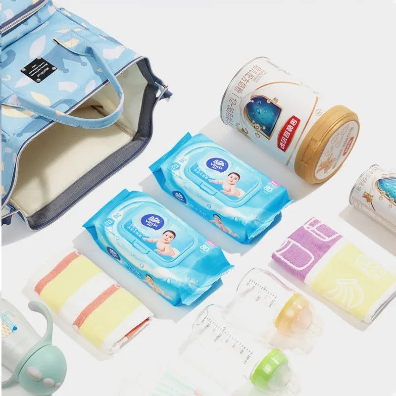 A stylish waterproof mummy backpack with a blue pattern on it, perfect for travel and as a diaper bag