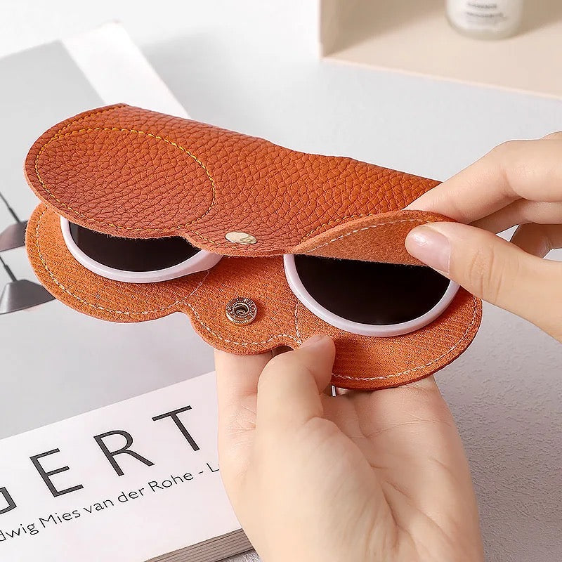 A unisex portable glasses bag, featuring a person holding an orange case containing sunglasses