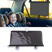 A young child sitting in a car seat with a retractable car sun shade blocking the sunlight